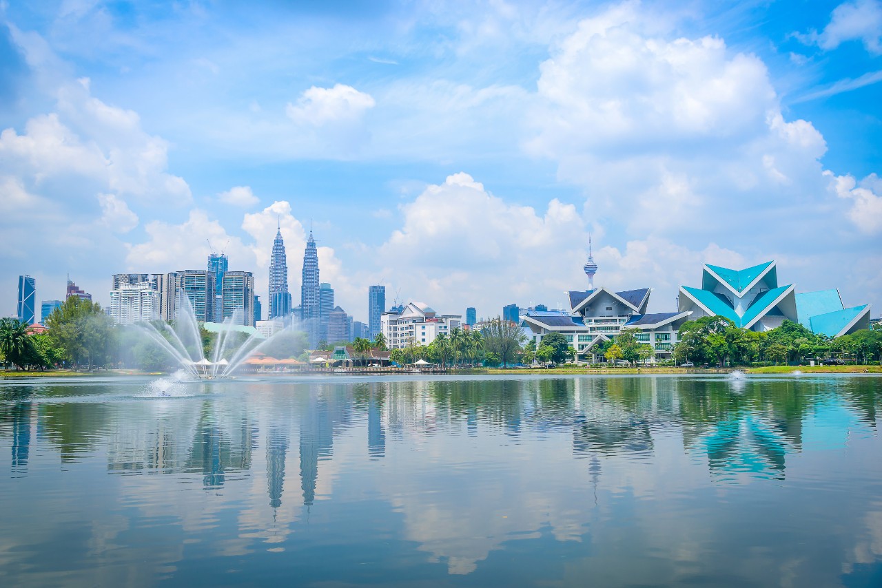Cityscape of Kuala lumpur city skyline on blue sky view from Titiwangsa park in Malaysia at daytime.